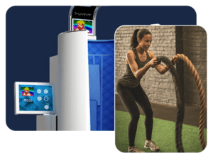 A woman is using an exercise machine and holding a rope.