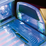 A computer with a keyboard and mouse on top of it.