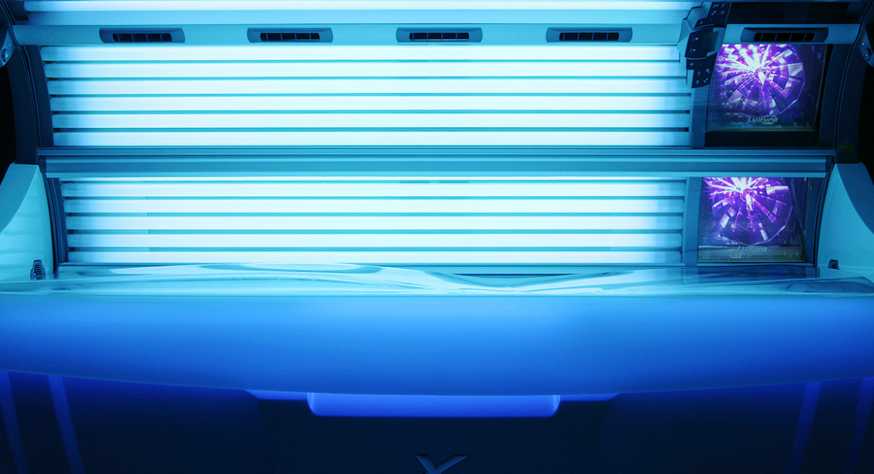 A Tan Bed With Blue Light and White Frame