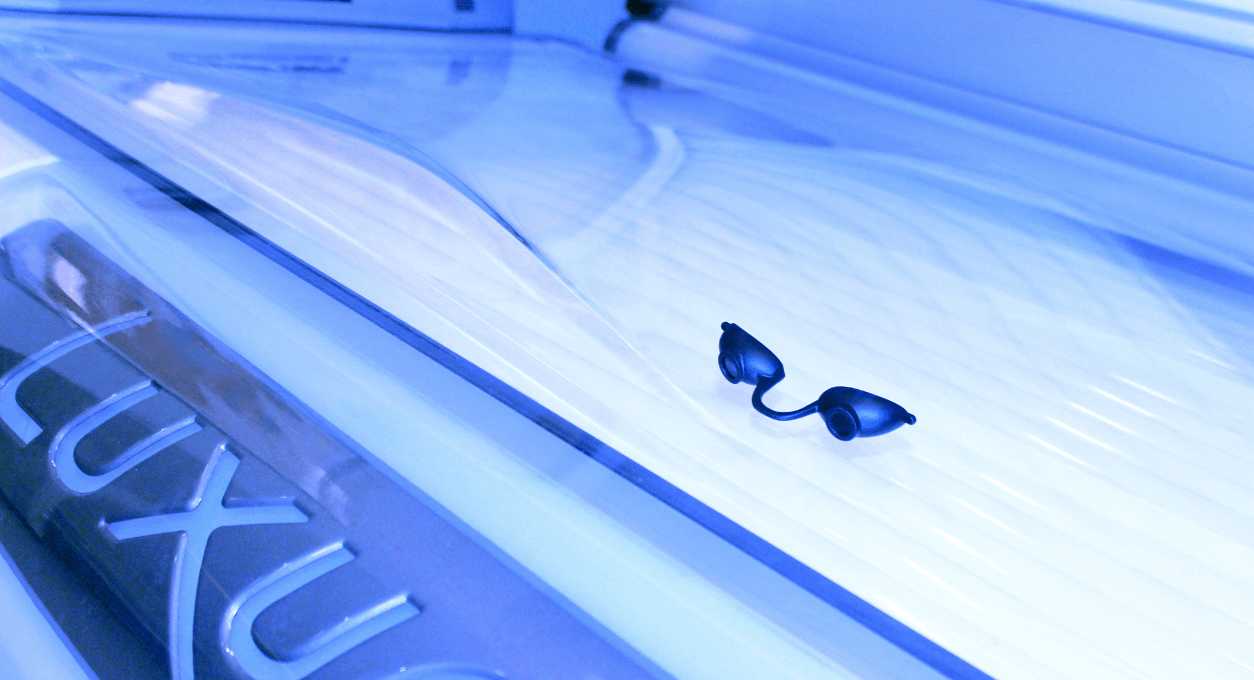 tanning glasses lying on lit bed