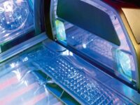 A computer with a keyboard and mouse on top of it.