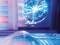 A computer screen with a blue light reflecting on it.