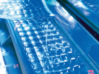 A keyboard with the keys lit up in blue light.